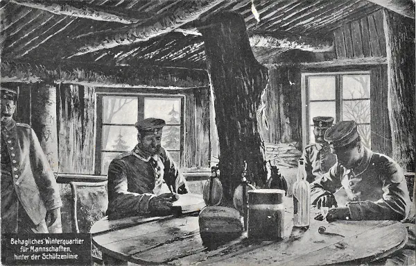 Soldaten sitzen in einem gemütlich eingerichteten Unterstand mit Fenstern am Tisch.